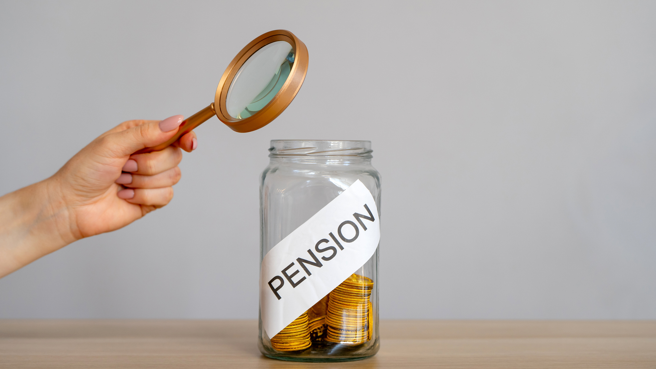 iStock 2197009451 uai -Bank of coins and the inscription Pension. Saving money and retirement concept. Accumulation of pension contributions. Business and finance. Magnifying glass | Piercefield Oliver