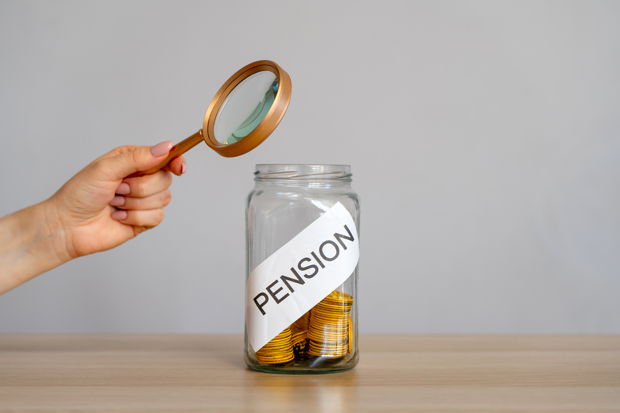 iStock 2197009451 -Bank of coins and the inscription Pension. Saving money and retirement concept. Accumulation of pension contributions. Business and finance. Magnifying glass | Piercefield Oliver