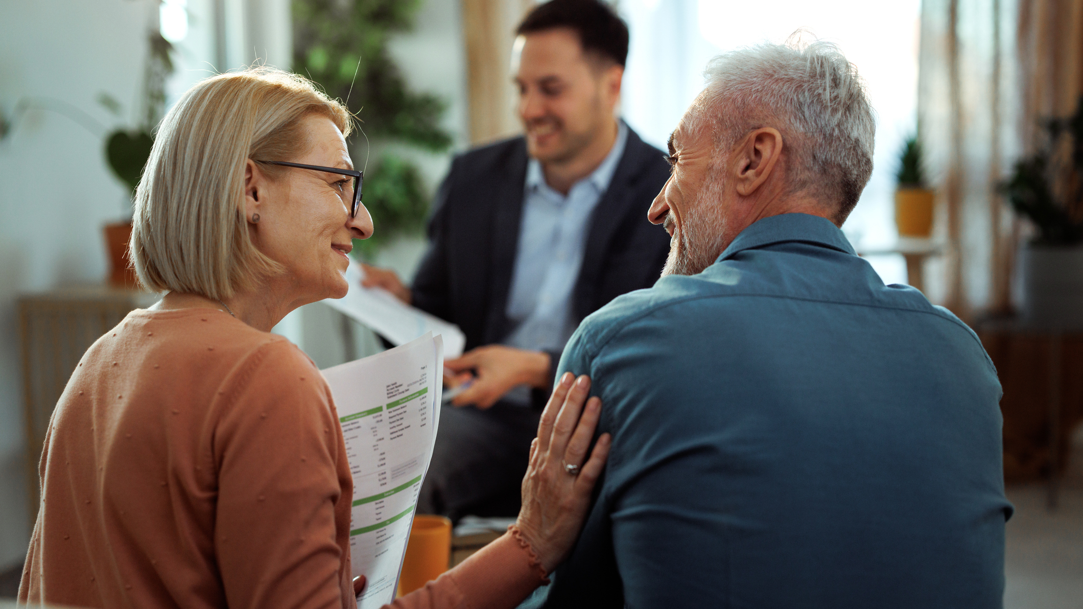 Mature couple having meeting with financial advisor at their aparemtnt 2 Meeting with financial advisor